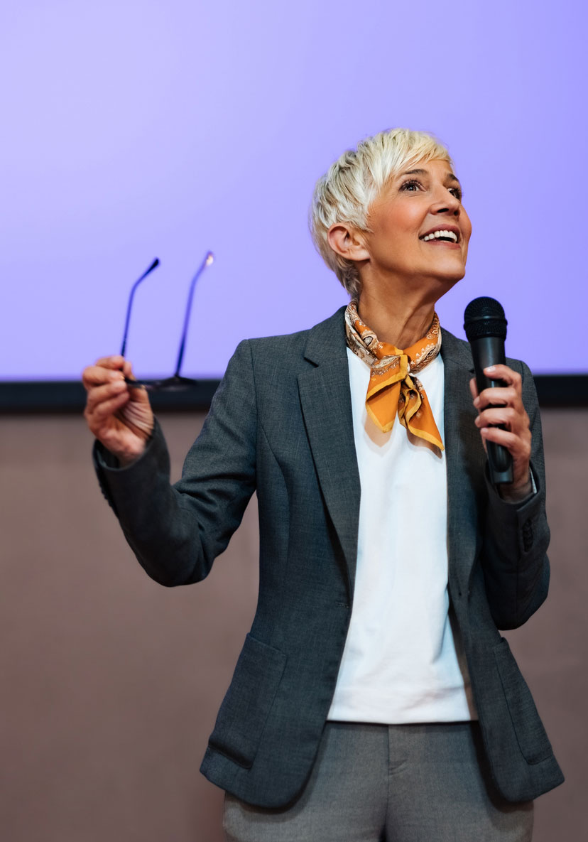 Speaker presenting on stage with confidence
