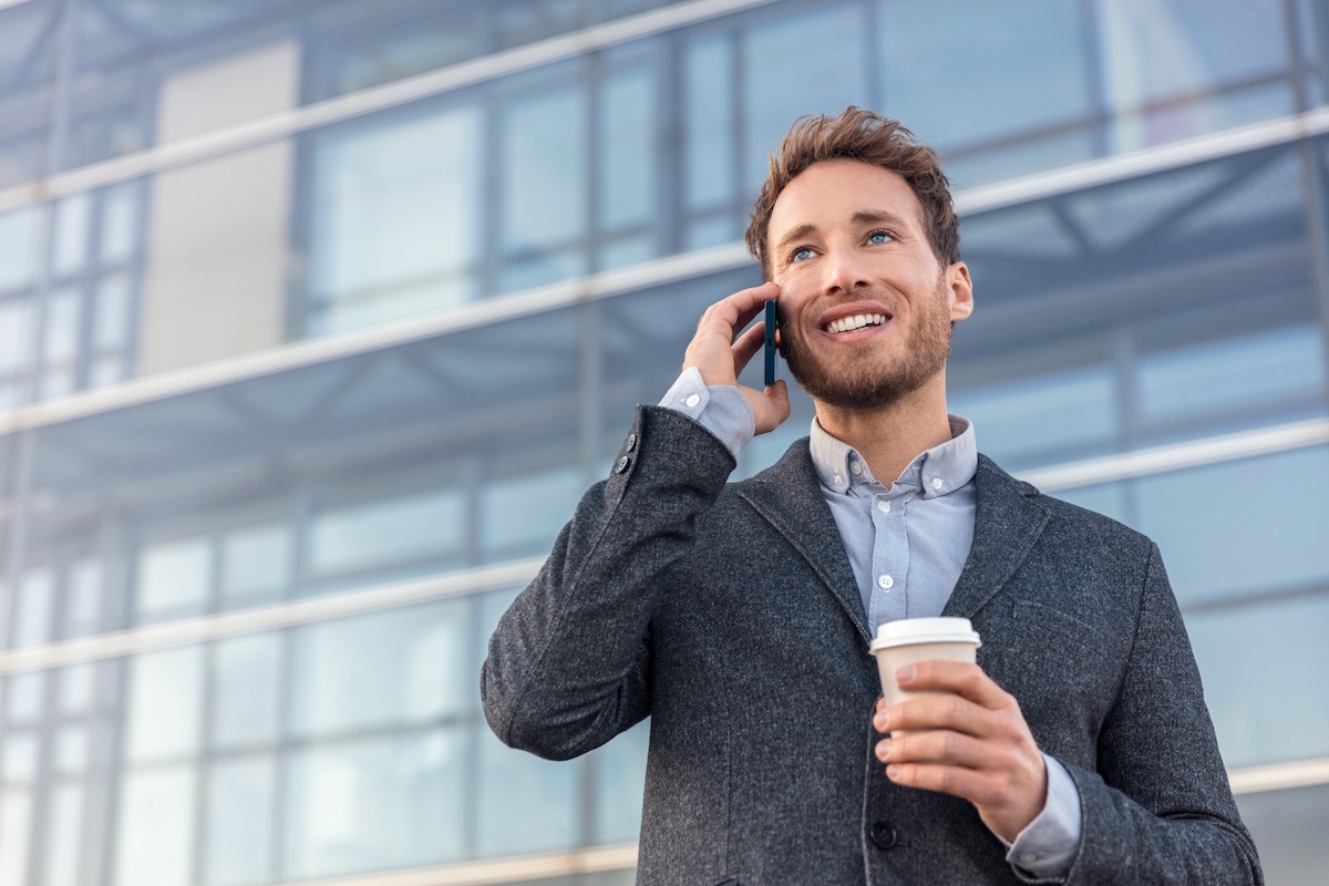 Businessman on the phone outside a modern building